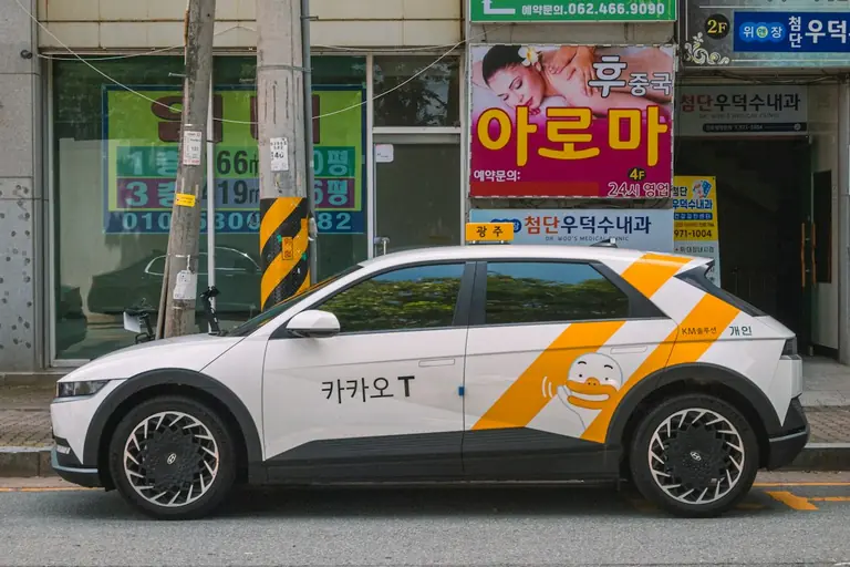 A kakao t taxi parked on a city street