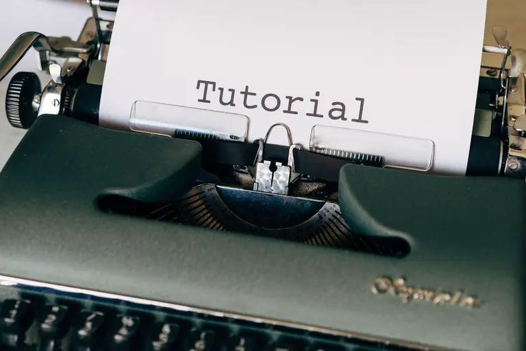 Close-up of a vintage typewriter with a sheet reading 'Tutorial'. Ideal for writing themes.