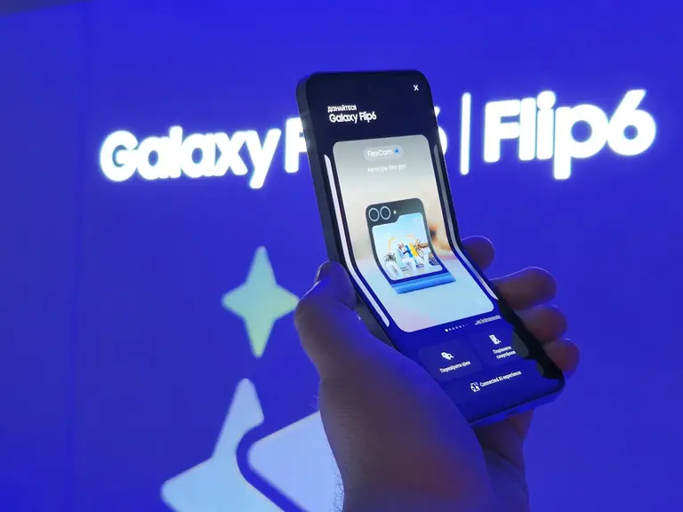 A person holding a smart phone in their hand