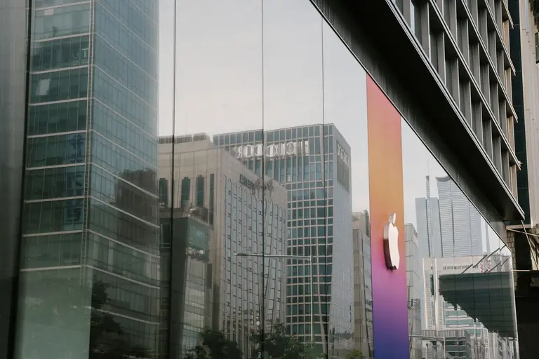 A city's reflection in a modern glass building facade capturing urban architecture and corporate design.