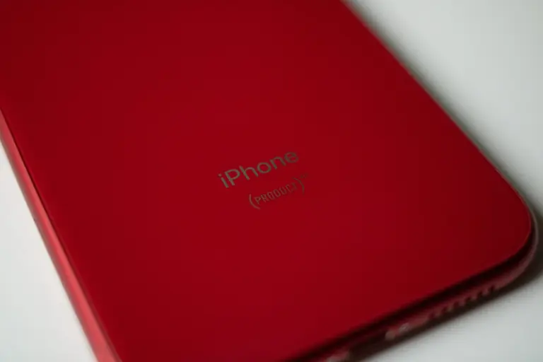 Elegant close-up of a sleek red smartphone design, highlighting contours and color.